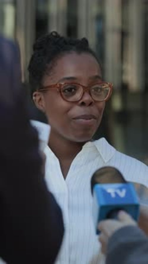 Woman Giving an Interview to Reporters