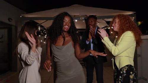 Friends Celebrating at Birthday Party on Rooftop at Night