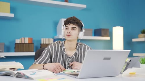 Young Adult Studying at Desk with Laptop