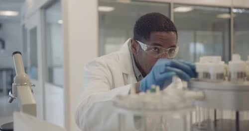 Man Scientist Working in Lab with Safety Glasses