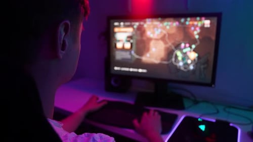 Closeup View From Shoulder of Unrecognizable Male Gamer Playing Online Match of Competitive Computer