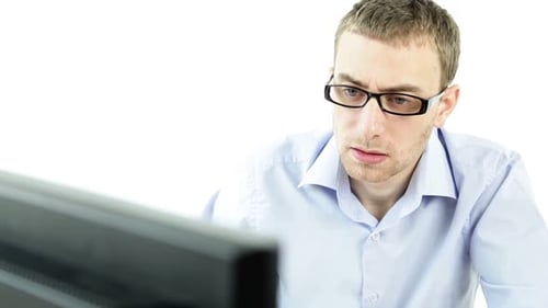 Man Looking at Computer Screen in Confusion