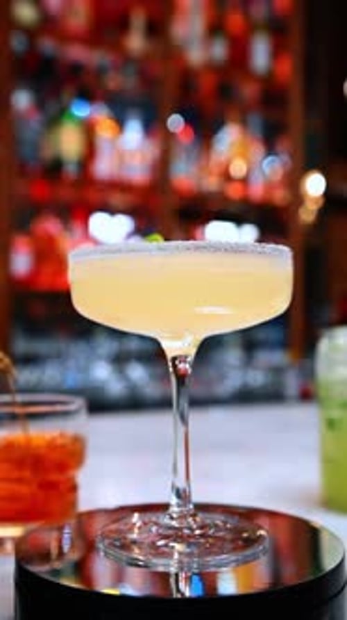 Lime garnish cocktail display. A lime garnished cocktail displayed against