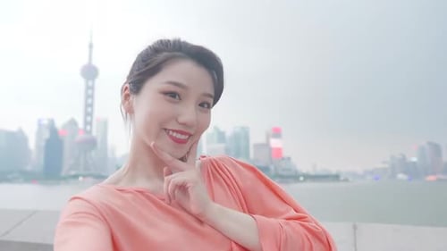 Woman Smiles in Front of City Skyline