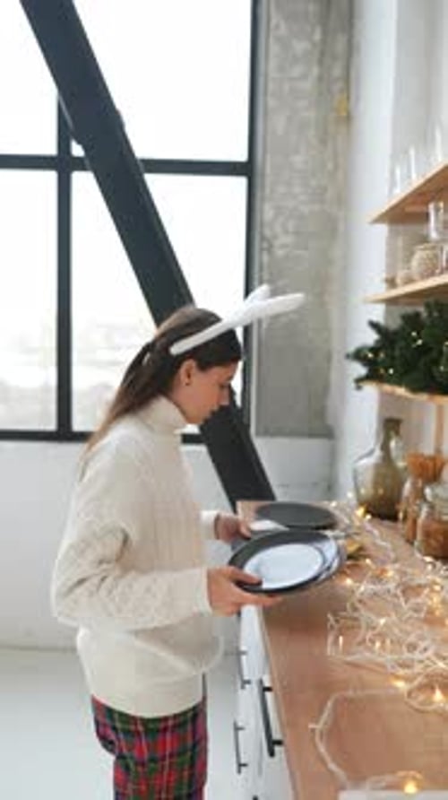 Woman With Bunny Ears Sets Holiday Dinner Table