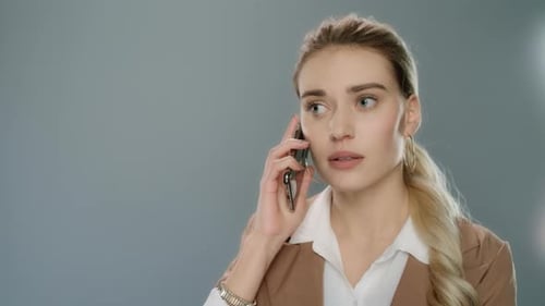 Angry woman talking on phone with upset expression