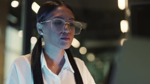 Closeup Of A Woman Working Closely On Her Laptop
