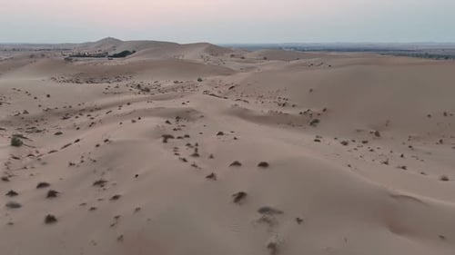 Aerial View Of Rolling Sand Dunes In Desert At Dusk