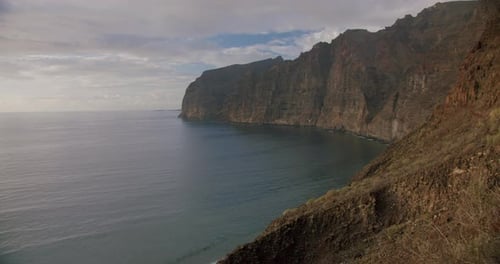 Los Gigantes steep huge cliffs rock wall bordering the blue atlantic ocean seascape. Tenerife, Spain