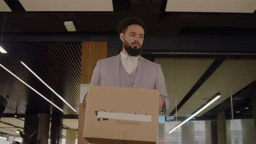 A Depressed Businessman Carrying a Heavy Box After Being Dismissed From His Office Place
