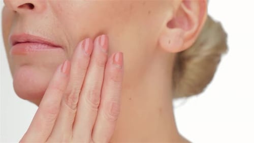 Close Up Of Woman Gently Touching Face