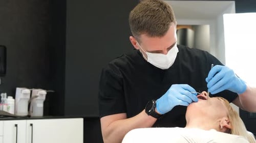 Dentist Performing Dental Procedure on Patient