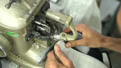 Worker Hands Sewing Soles In Shoe Factory