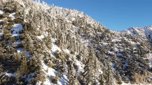 Aerial of a road through the mountains after a snow