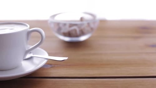 Breakfast Objects and Drinks Concept - Cream Pouring to Coffee Cup On