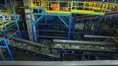 Aerial view of conveyor belt of recycling factory automatically sorting trash
