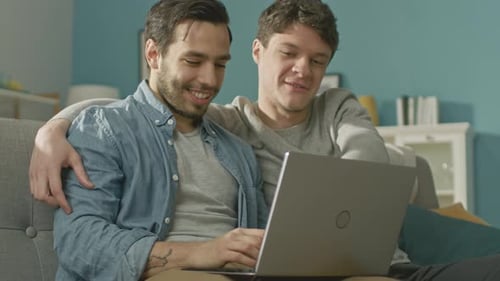 Affectionate Couple Using Laptop Together at Home