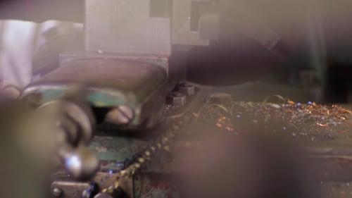 shop on the countryside using a lathe and tightening a bolt.