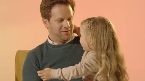 Loving Father Hugs His Young Daughter