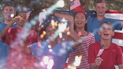 Smiling children hold American flags with sparklers