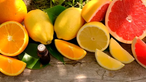Citrus Fruits with Essential Oil on Wood