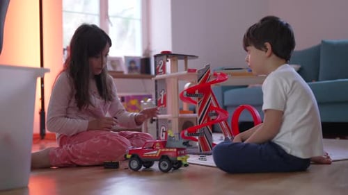Children Playing with Toy Cars and Garage at Home