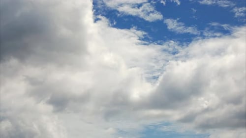 White Clouds Moving Across Vibrant Blue Sky