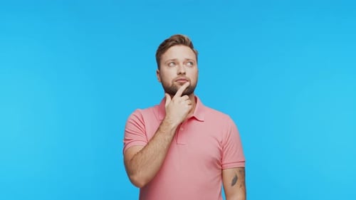Thinking Young Man Over Vibrant Background Studio Portrait of Expressive Handsome Person