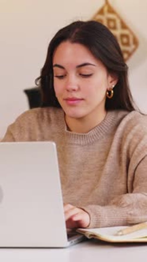 Young Woman Works on Computer at Home