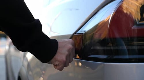 Electric Car Being Plugged in to Charge