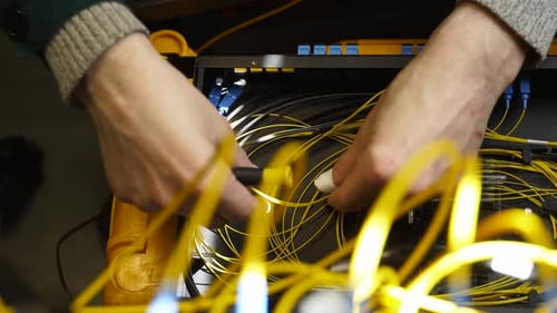 Worker Connects Optical Line Internet Wire in Connection Box Service Man Soldering Optical Fiber