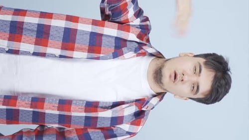 Young Adult Man Fanning Himself in Vertical Video