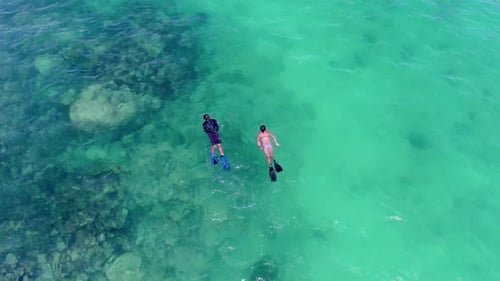 Couple snorkeling in turquoise tropical waters of the bahamas on summer vacation