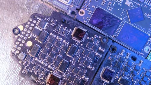 Rotating surface of microcircuits flashing blue neon light. Modern nano-digital technologies chips