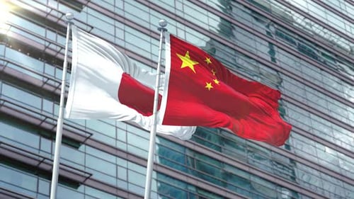Japan and China Flags Waving on Modern Building Background
