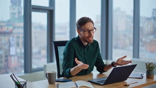 Experienced Consultant Talking Virtual Meeting Holding Papers in Office Closeup