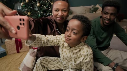 Family Taking Christmas Selfie in Decorated Home