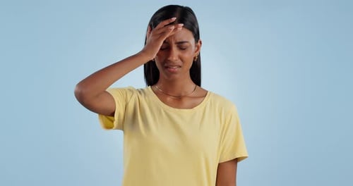 Stress, headache and face of Indian woman in studio with mistake, problem and fail with anxiety
