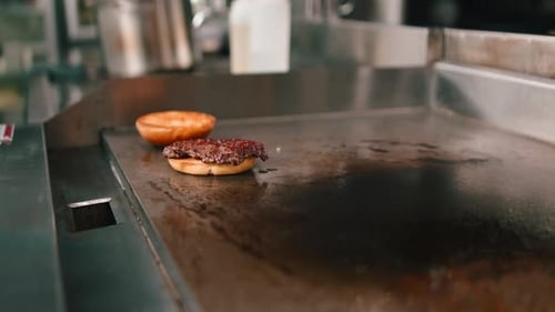 Burger Toasted Bun Assembled with Sauce on Grill