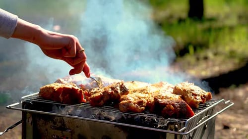 Cooking Steaks Process Meat Chops in Smoke on Outside Grill Woman Flipping Juicy Steaks on Bbq