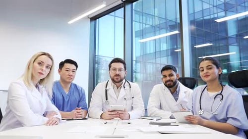 Webcam view. Team of doctors communicate at online conference by video call looking at camera