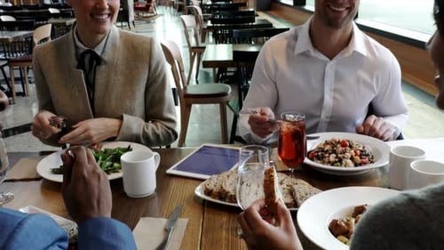 Business People Enjoying Working Lunch In Restaurant