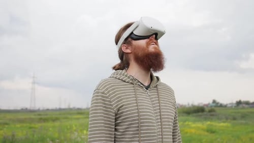 A Man Using a VR Headset on Nature and Turns His Head Around