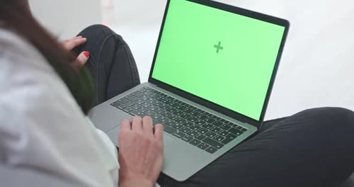 Woman Typing on Laptop with Green Screen