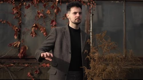 Stylish Man Waving in front of an Old Building