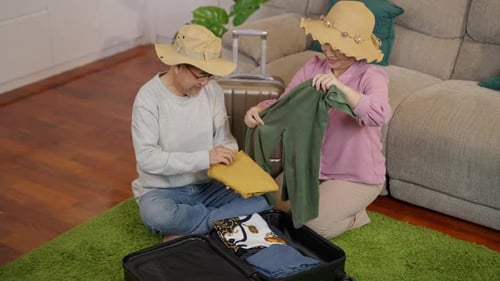 Couple Packing Suitcase Together at Home for Vacation