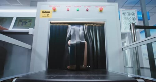 Airport Security Checkpoint Passenger Takes Suitcase From Conveyor Belt After Luggage Screening