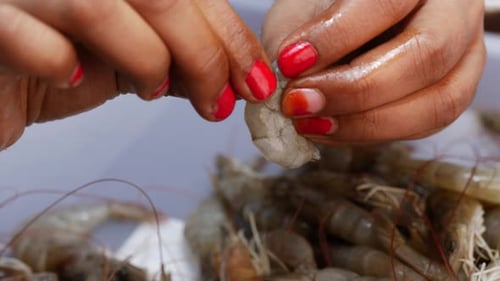 Hands Peeling Raw Shrimp For Food Preparation
