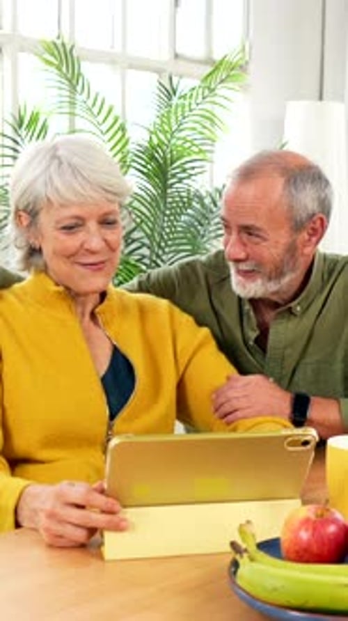 Elderly Couple Looking at Tablet Together
