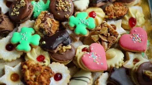 Close-up view of decorated Christmas cookies on a gold plate of different colors and species capture